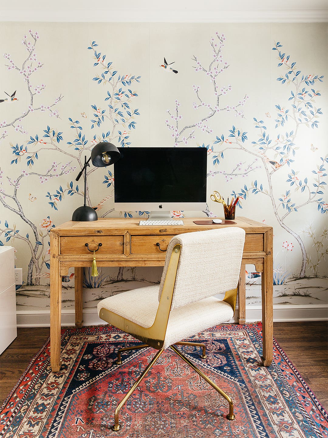 wood desk and floral wallpaper