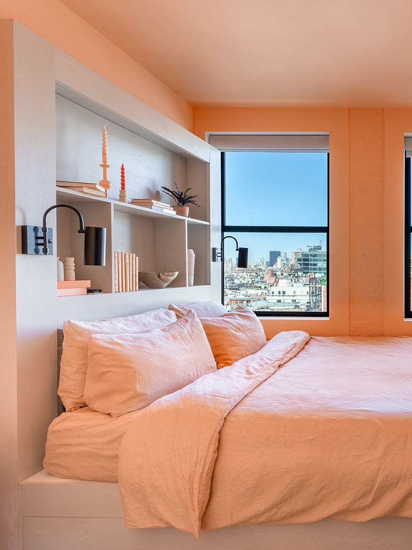 Walker Hotel Room with peach walls, bedding and fridge