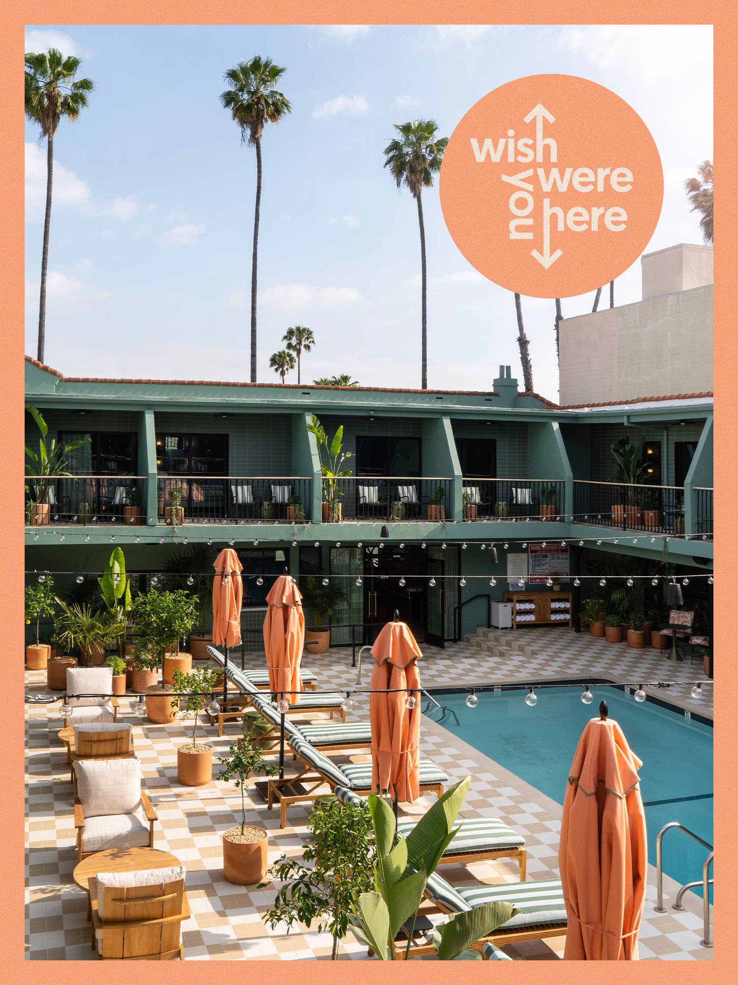 A pool with pink umbrellas and striped chaises and sticker that says "wish you were here"